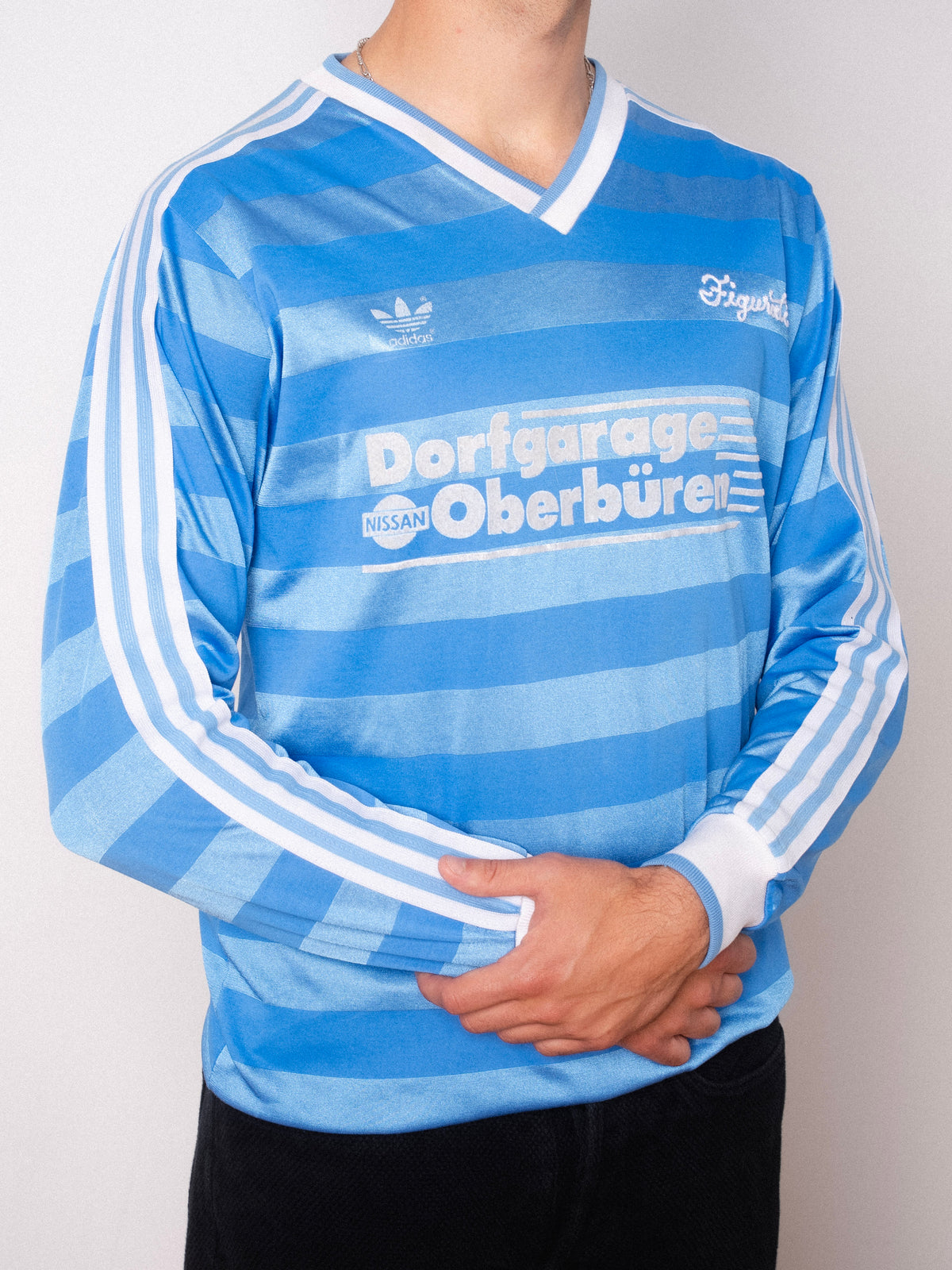 Vintage Adidas light blue striped long sleeve football shirt with Dorfgarage Oberburen sponsor and Figurati embroidery, styled