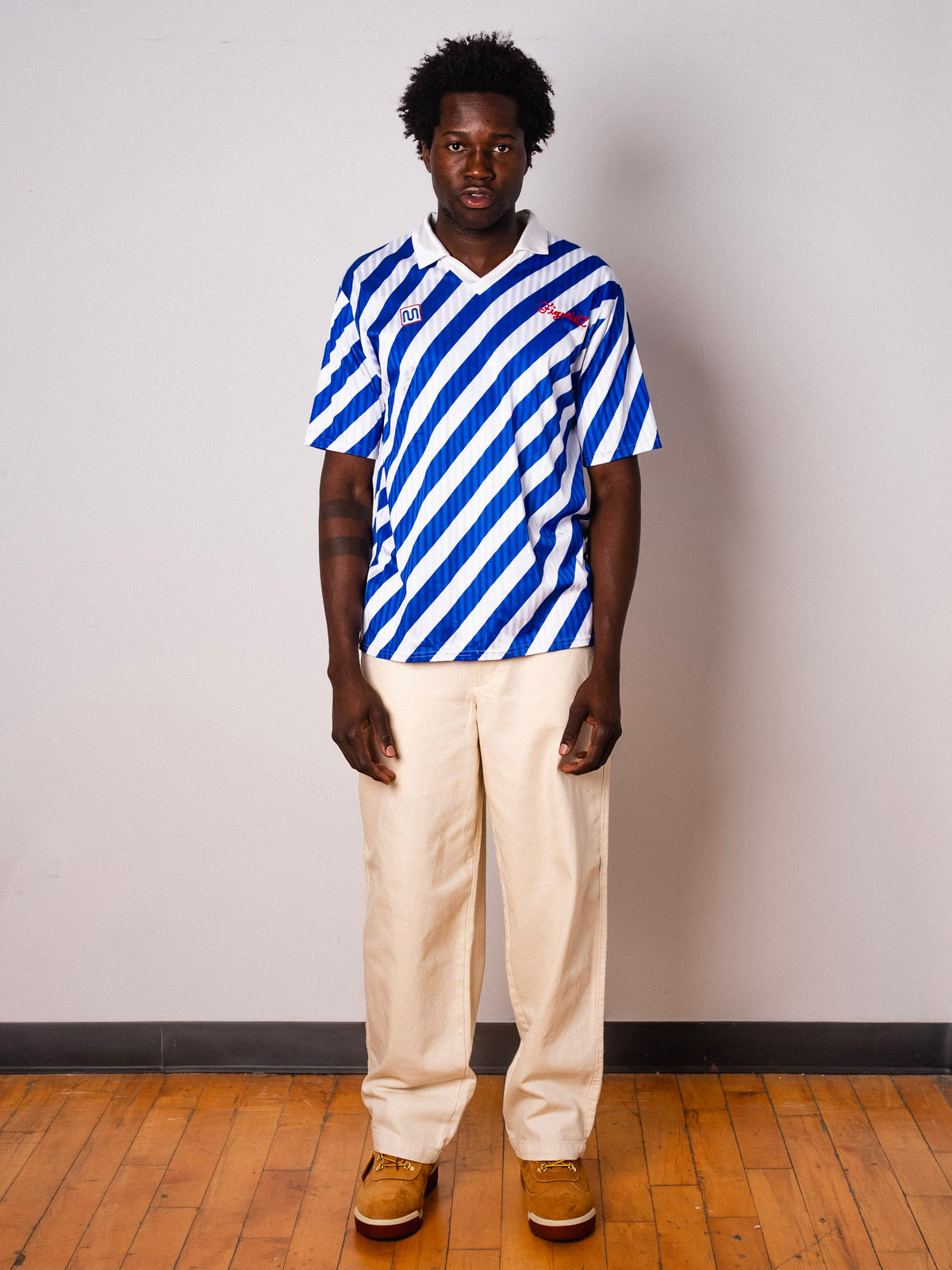 Vintage Meyba blue and white diagonal stripe short sleeve football shirt with Figurati embroidery, full body front