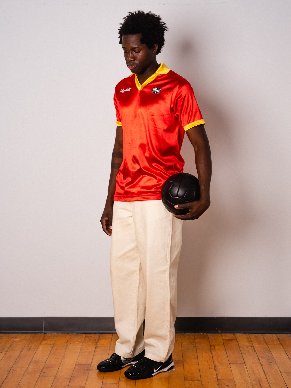 Vintage Ennerre red satin short sleeve football shirt with yellow collar and Figurati embroidery, full body front
