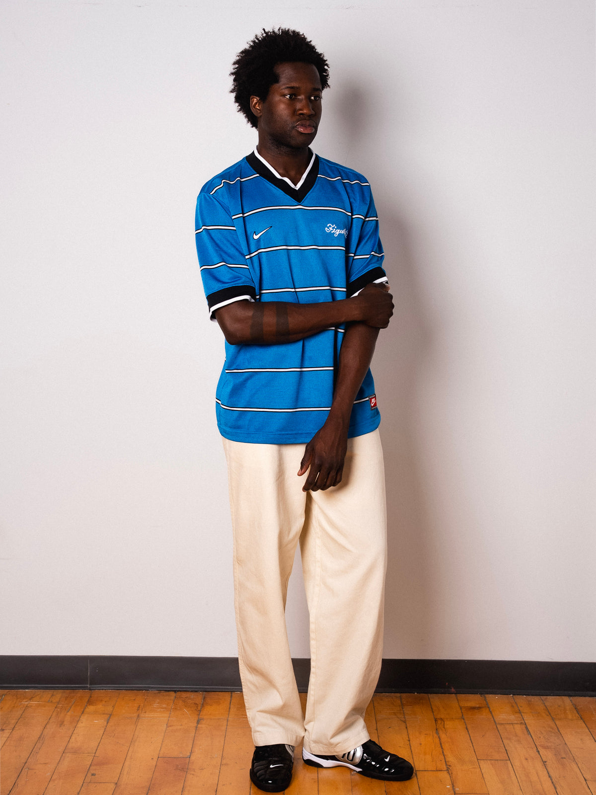 Vintage Nike blue striped short sleeve football shirt with Figurati embroidery, full body front