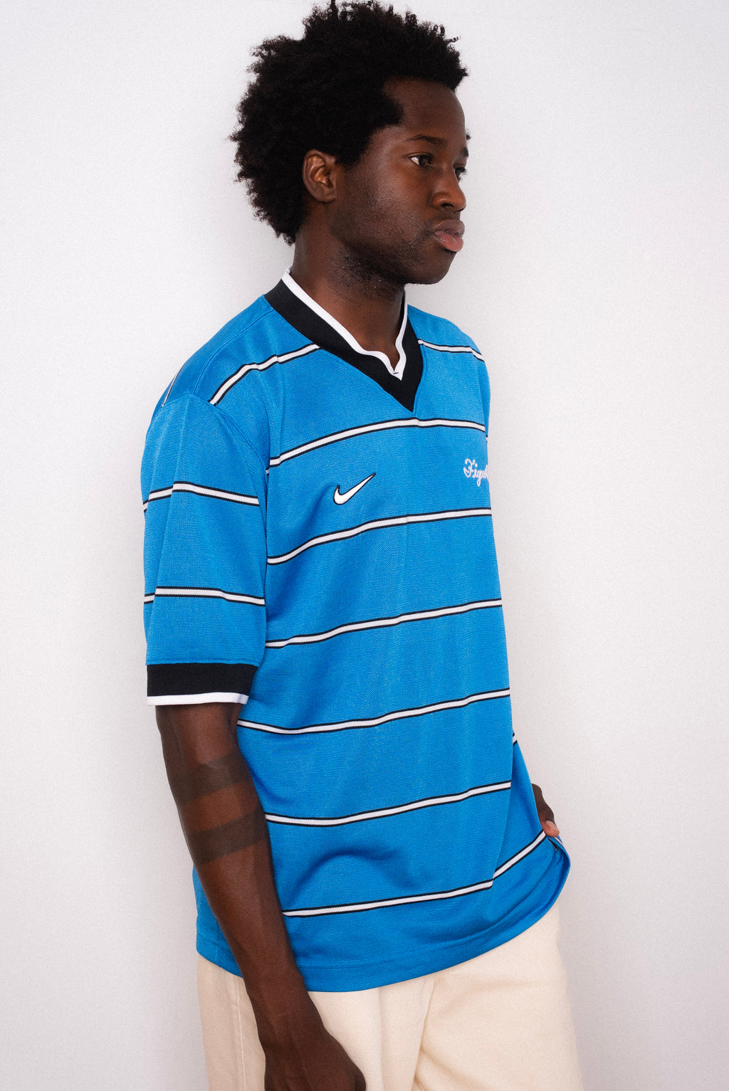 Vintage Nike blue striped short sleeve football shirt with Figurati embroidery, styled