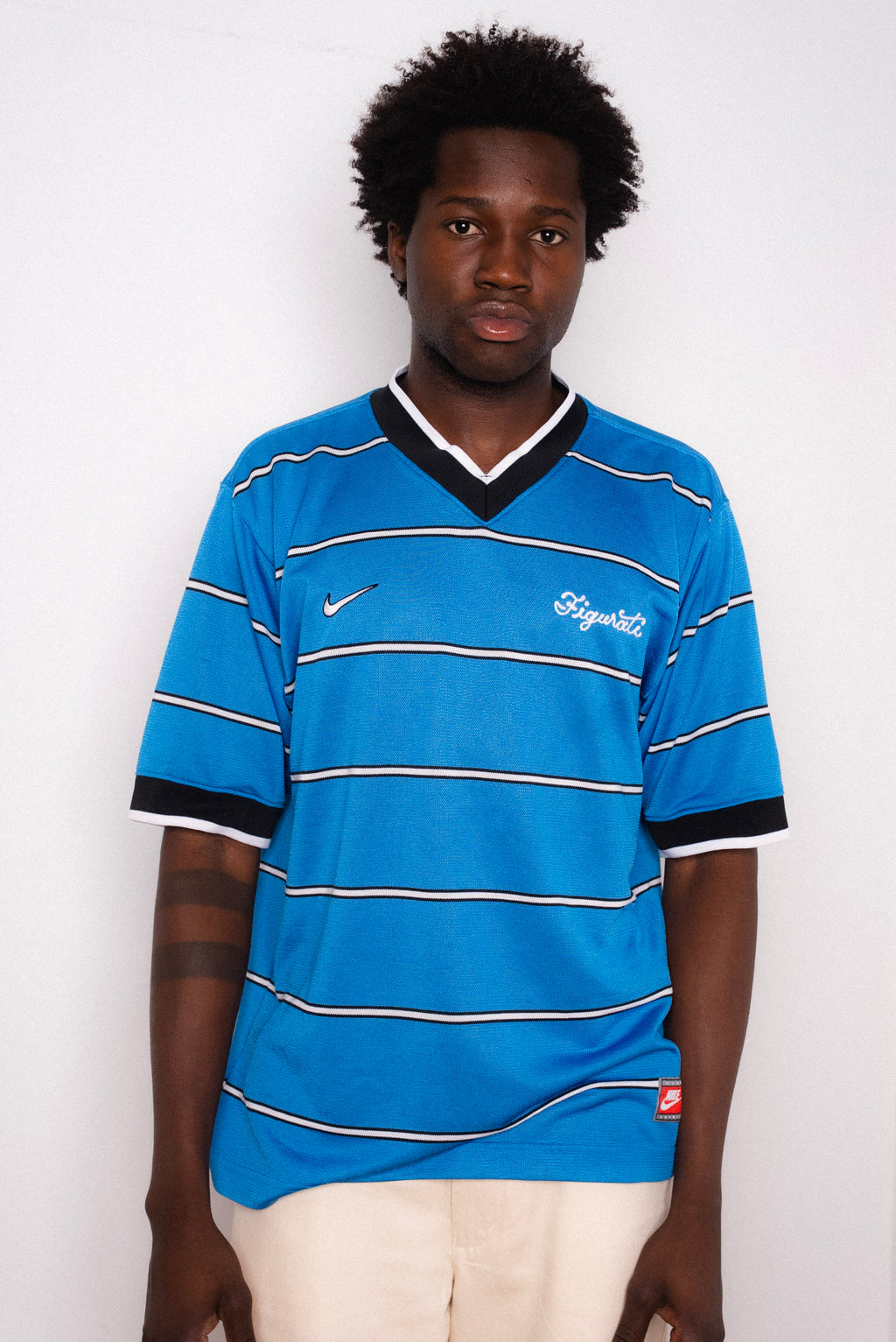 Vintage Nike blue striped short sleeve football shirt with Figurati embroidery, styled