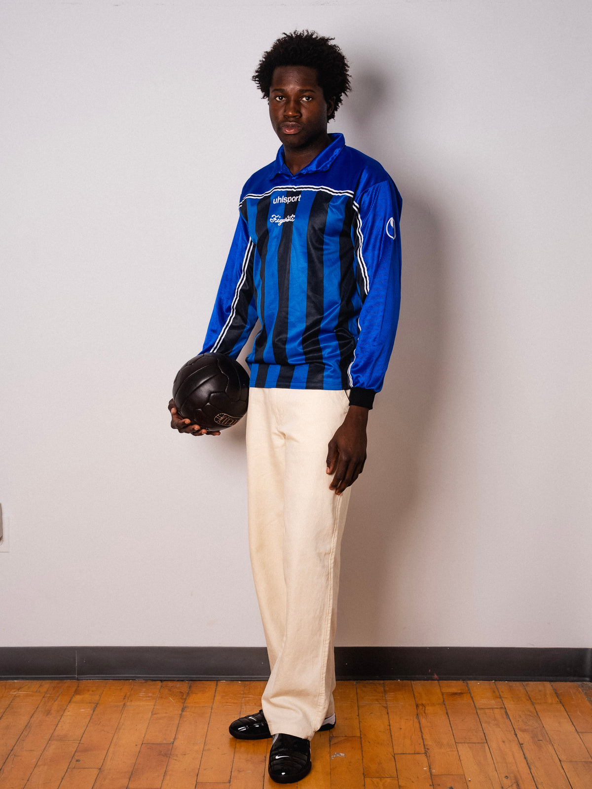 Vintage Uhlsport blue and black striped long sleeve football shirt with Figurati embroidery, full body front