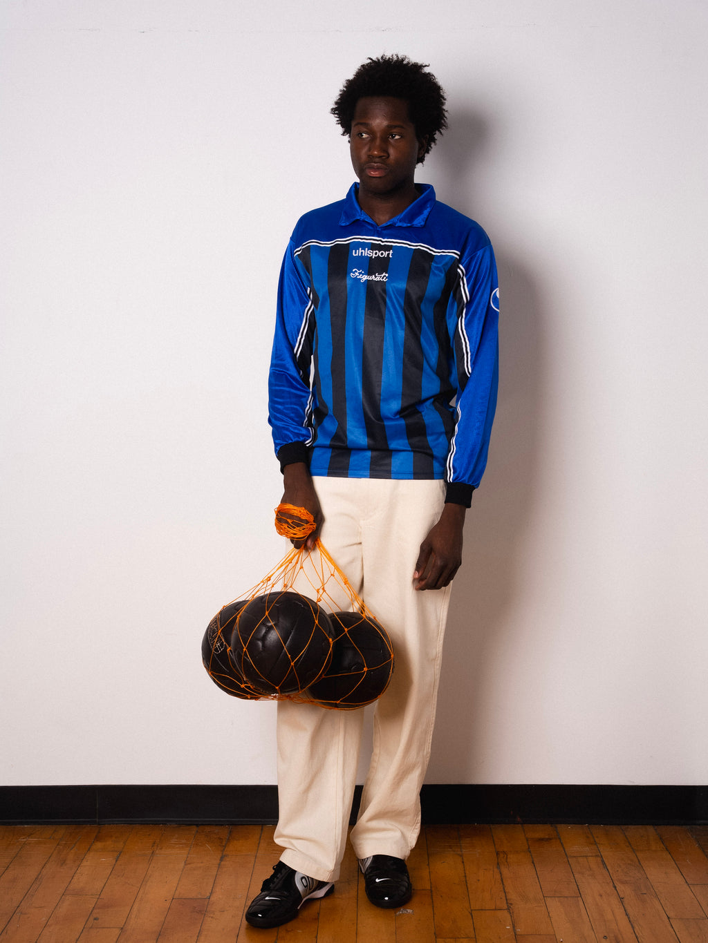 Vintage Uhlsport blue and black striped long sleeve football shirt with Figurati embroidery, full body front