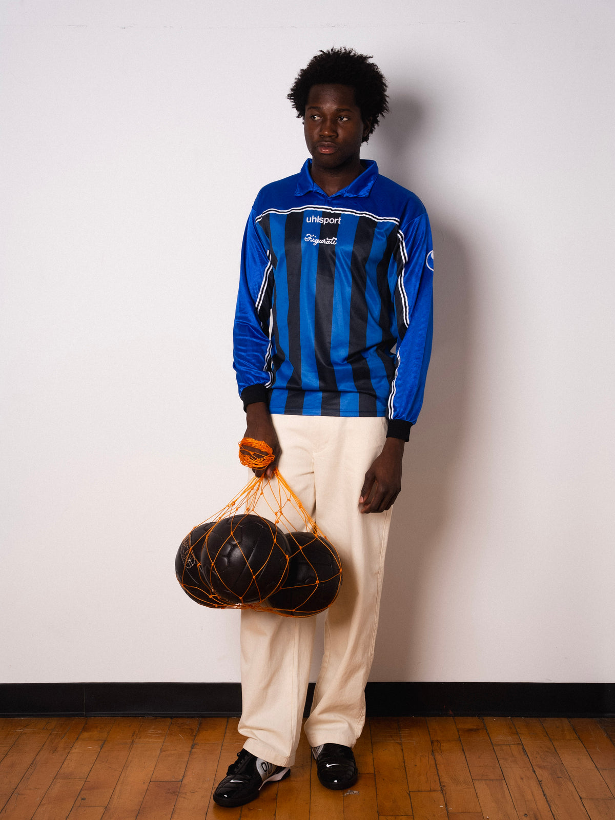Vintage Uhlsport blue and black striped long sleeve football shirt with Figurati embroidery, full body front