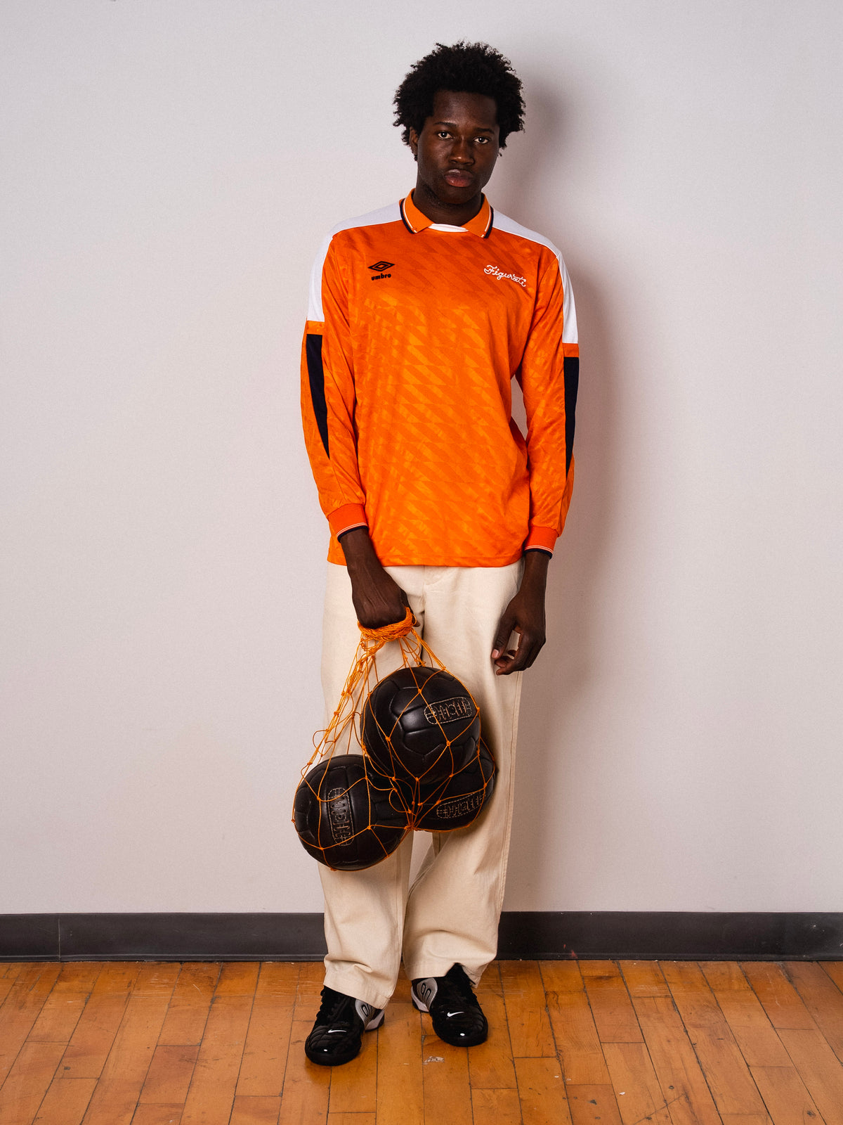 Vintage Umbro orange long sleeve football shirt with Figurati embroidery, full body front with ball net