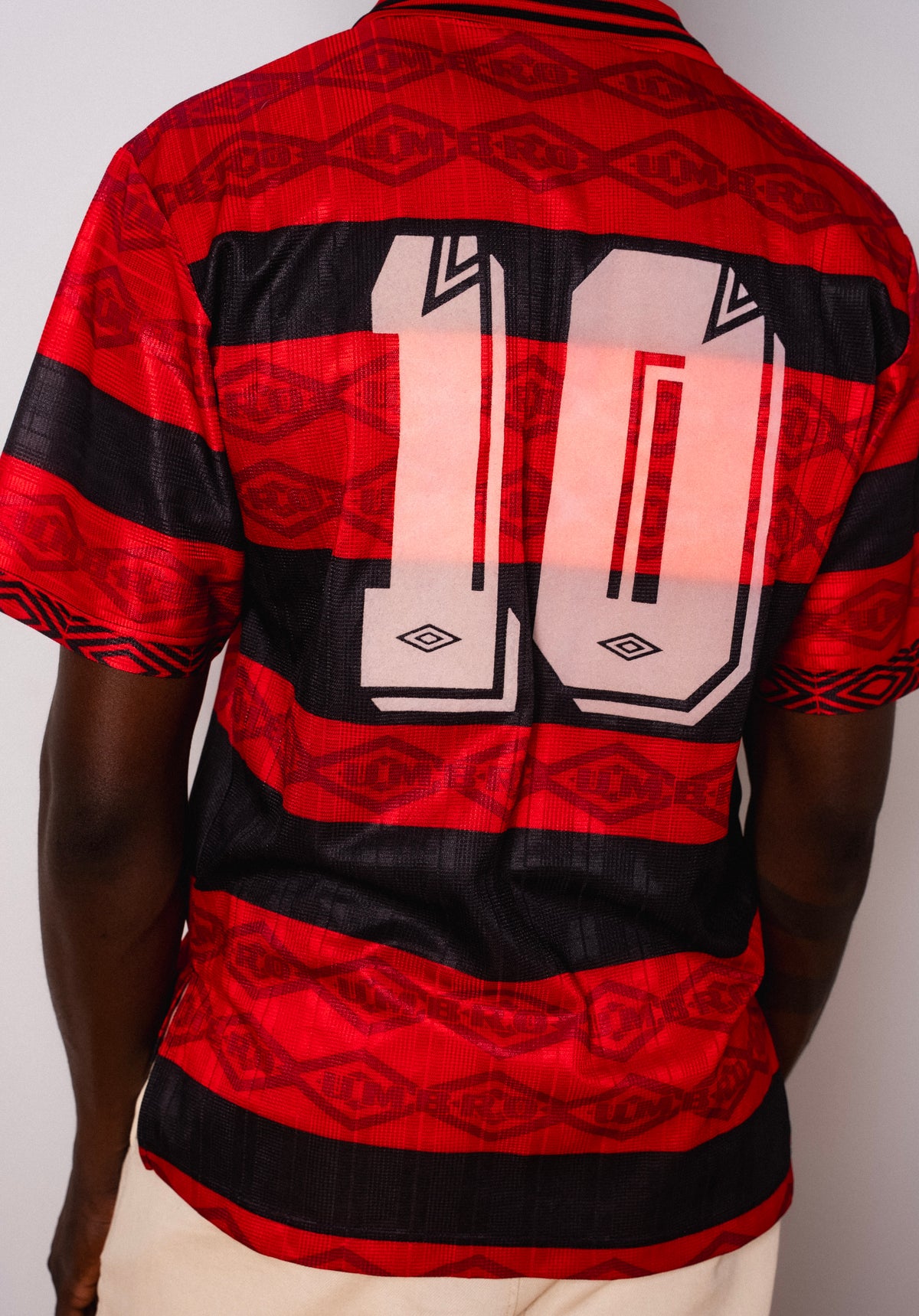 Vintage Umbro red and black striped short sleeve football shirt with Figurati embroidery, back
